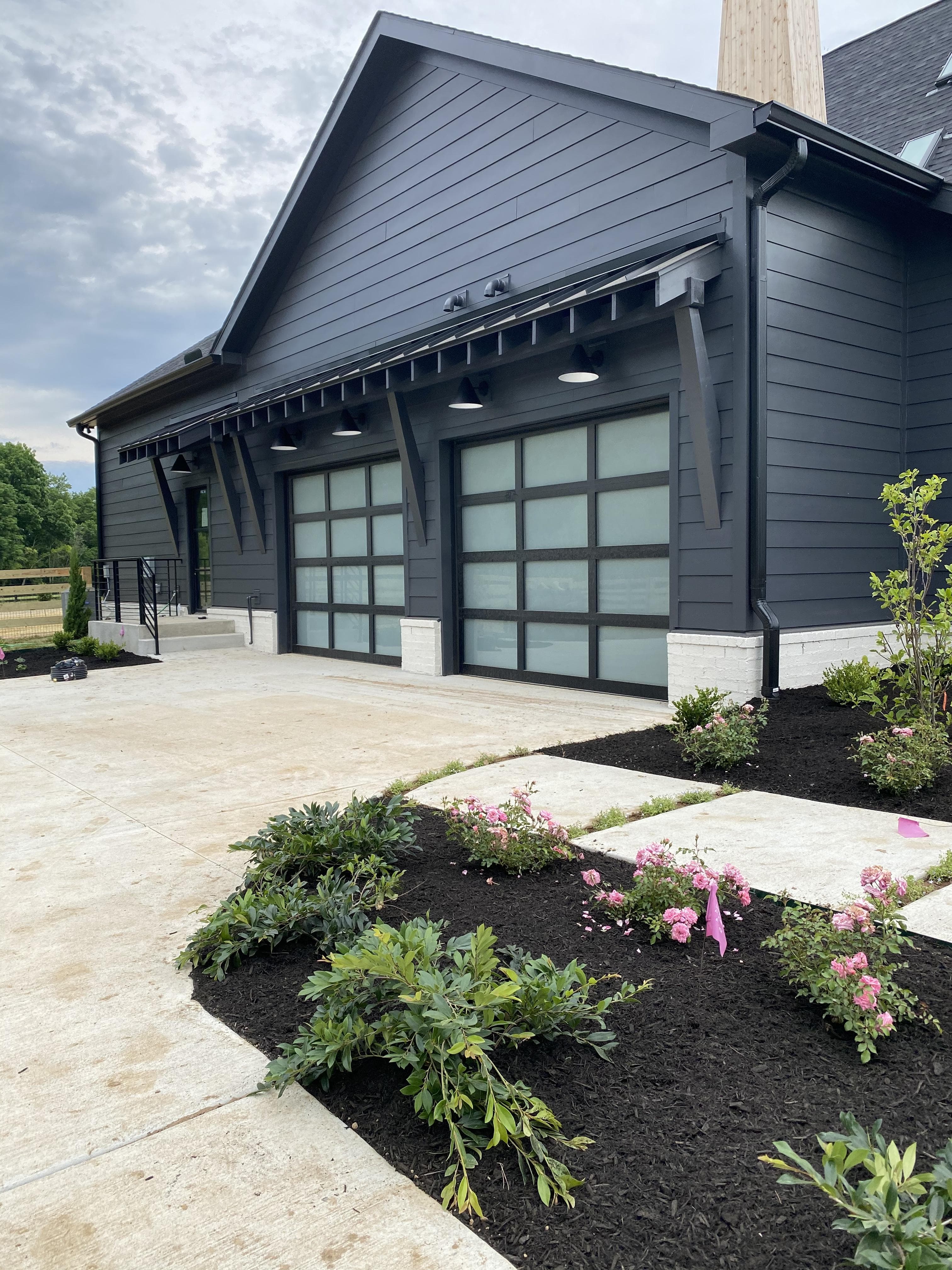 Garage door repair technician inspecting a residential garage door in Calgary